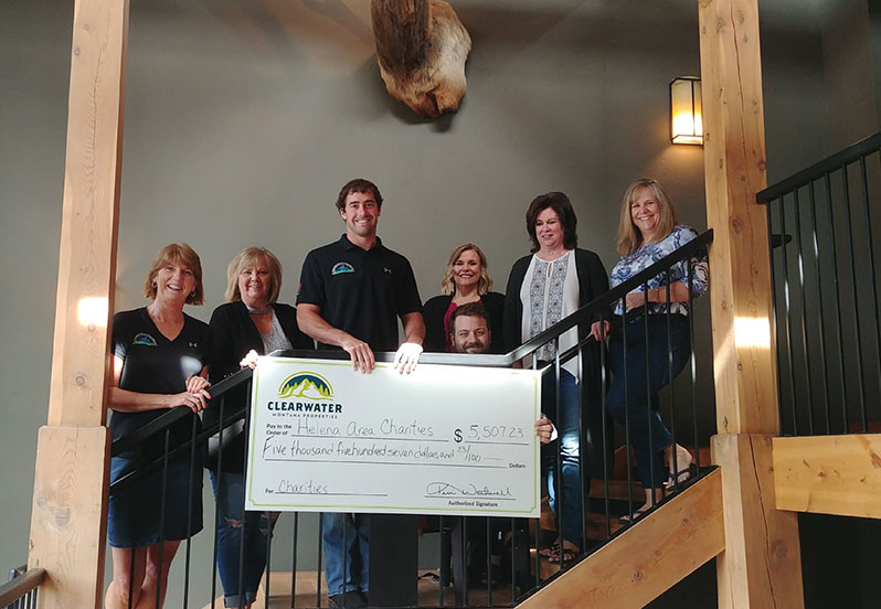 Clearwater agents holding a donation check