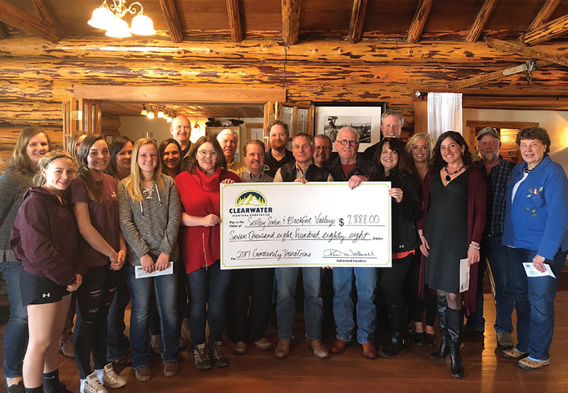 Clearwater agents holding a giant donation check